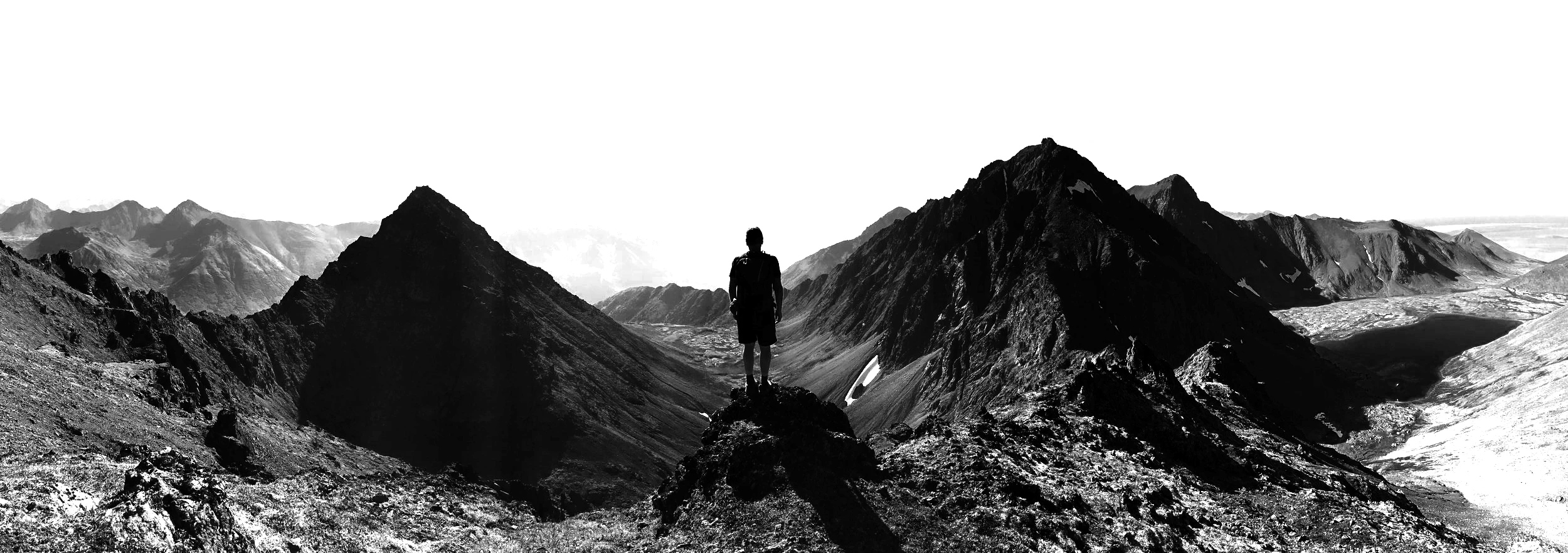 A wide black and white mountain panorama.